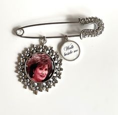 a brooch with a picture of a woman on it