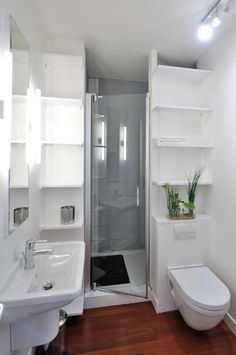 a bathroom with a toilet, sink, and shower stall is shown in this image