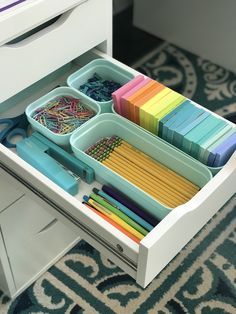 an organized drawer is shown with scissors and other crafting supplies