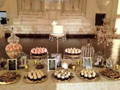 a table topped with lots of desserts and pastries