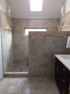 a bathroom with a walk in shower next to a sink