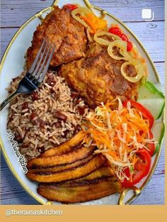 a white plate topped with rice, meat and veggies next to a fork