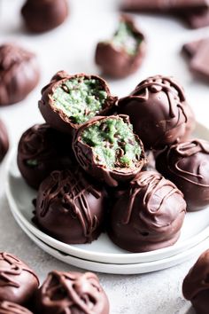 some chocolates are on a white plate