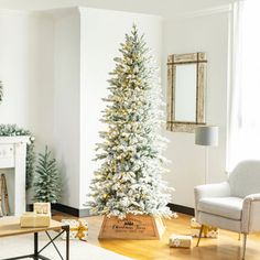 a living room decorated for christmas with white and gold decorations on the tree, fireplace mantels and chairs