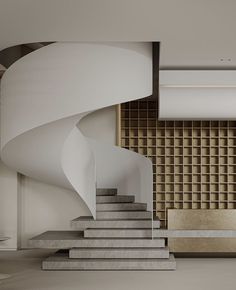 a spiral staircase in an empty room with white walls and concrete steps leading up to the second floor