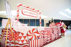 people standing in front of a large display with red and white wrappings on it