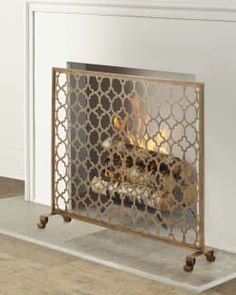 an ornate fireplace screen with candles in it