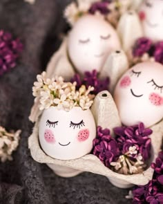 some eggs with faces painted on them and flowers