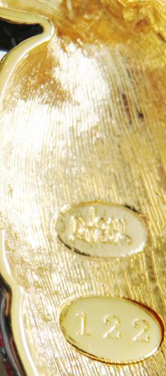 a close up view of the inside of a gold pocket watch with numbers on it