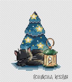 a cross stitch pattern with a cat sleeping next to a christmas tree