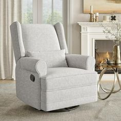 a living room with a rocking chair next to a fire place