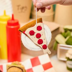 a slice of pizza hanging from a string