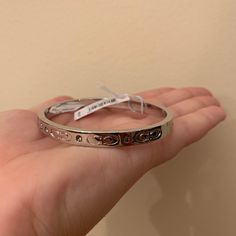 I Purchased The Bracelet And It Is Lovely! It Is Brand New! I Purchased It For $80, It Was Originally Priced At $88. It Has A Clasp That Does Not Allow For The Bracket To Fall Off And Has Beautiful Details On The Side Of The Bracelet. It Is A Beautiful Piece To Add To A Coach Lovers Collection! Coach Adjustable Bangle, Adjustable Coach Bangle, Classic Coach Bangle Jewelry, Coach Bracelets As Gift, Coach Classic Bangle Jewelry, Coach Classic Bangle, Coach Metal Bracelet Jewelry, Coach Metal Bangle Jewelry, Elegant Coach Bangle Jewelry