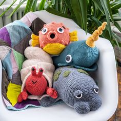 crocheted stuffed animals sitting on top of a white chair