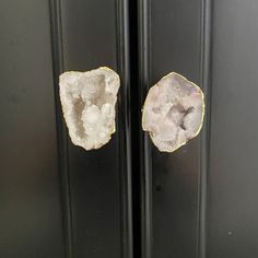 two pieces of rock sitting on top of a black cabinet