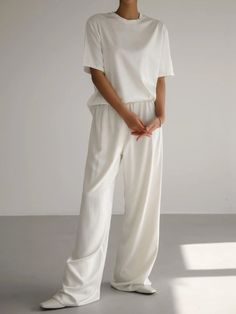 Chic and luxurious silky satin banded trousers with wide leg. Relaxed flowing pants that are easy to wear and a comfortable style and fit. Model is in MINUSEY ONE SIZE. ✔️ Free worldwide express shipping over $100 ✔️ Loved by 6,500+ customers ✔️ Limited edition collections, maximum style ⠀⠀⠀⠀⠀⠀⠀⠀⠀ Stay ahead of the tre White Silk Wide-leg Pants, Chic White Silk Wide Leg Pants, White Silk Pants For Summer, Casual Silk Wide Leg Loungewear Pants, Casual Silk Wide Leg Pants With Elastic Waistband, Summer Silk Wide Leg Pants For Loungewear, White Silk Wide Leg Pants, White Silk Long Pants, Silk Wide Leg Casual Pants