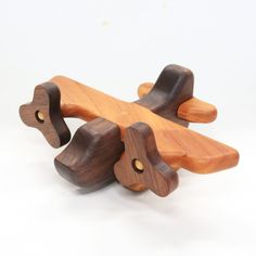 a wooden toy airplane sitting on top of a white table