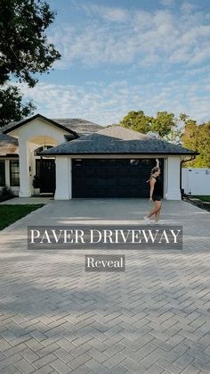 a woman walking across a driveway in front of a house with the words paver driveway reveal