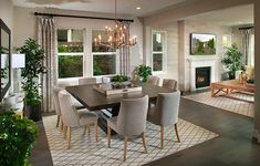 a dining room table with chairs and a chandelier hanging from it's ceiling