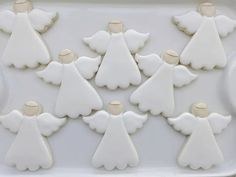 decorated cookies in the shape of angels on a tray