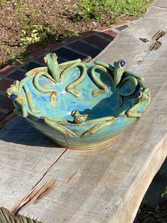 a ceramic bowl sitting on top of a wooden bench