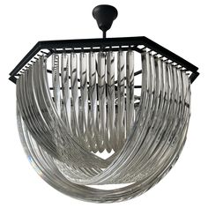 a modern chandelier made out of glass tubes and black metal rods on an isolated white background