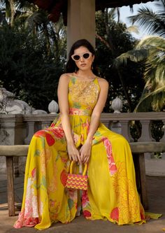 The lime yellow big floral jumpsuit is perfect for destination wedding celebrations, details of dramatic, flowy and easy breezy silhouette makes the fit more chic and classic, the bodice is hand highlighted on digitally printed flowers using tone to tone sequins, moti, mirror and cutdana. It is styled with same printed belt to accentuate the waist. Elegant Floral Print Palazzo Set For Party, Summer Party Sets With Printed Motifs, Summer Floral Print Palazzo Set For Parties, Summer Party Palazzo Set With Floral Print, Elegant Summer Palazzo Set With Printed Motifs, Spring Party Palazzo Set With Printed Motifs, Floor-length Printed Palazzo Set For Party, Yellow Palazzo Set With Printed Motifs For Wedding, Wedding Yellow Palazzo Set With Printed Motifs