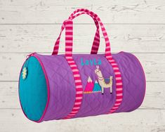 a purple and blue duffle bag with an image of a llama on it