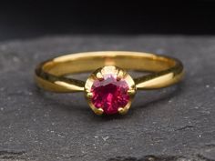 Solitaire Ruby Ring set with a Created Ruby in a flawless diamond cut & deep red color, at 5mm. Band width 2.3mm. Promise Ruby Ring made of Gold Vermeil ☞ 18k Gold Plating on top of Solid 925 Sterling Silver. Matching Pendant & Earrings - please ask me Details : ♥ Each item comes in a cute GIFT BOX ✓ ♥ GUARANTEE on the materials ✓ ♥ Created Ruby - diamond cut, flawless clarity & deep red color ✓ ♥ Pure Solid 925 Sterling Silver ☞ Silver Hallmark on each piece ♕ ♥ The ring is plated with 18k Gold Ruby Ring Engagement, Red Diamond Ring, Ruby Ring Set, Gold Ruby Ring, July Birthstone Ring, Ruby Bands, Ruby Ring Gold, Flawless Diamond, Cute Gift Boxes