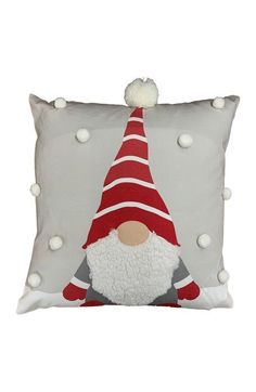 a pillow with a gnome on it and pom - poms around the edges