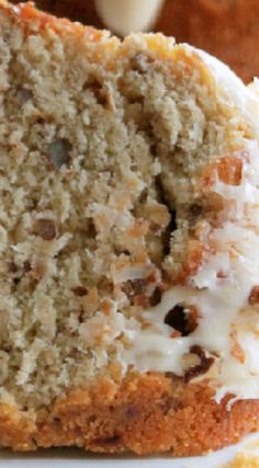 a close up of a piece of cake with frosting and pecans on top