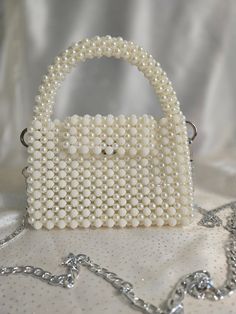 Handmade Pearl and White Beaded Bag with Silver-Toned Hardware This elegant handbag, crafted from pearl beads 8mm and white beads 10mm, features silver-toned hardware and a 47-inch removable chain. The magnetic closure adds convenience and ease of use. Our bags are 100% handmade. Each bag is unique and crafted with love for our customers. It takes 3-5 days to create one bag. A perfect gift for women, friend, family member or loved one. Ideal for any celebration, event, wedding or birthday party. White Evening Bag With Pearl Chain, White Pearl Bag With Pearl Chain, White Bags With Pearl Chain, Hand Beaded Bag, Elegant Handbag, Bead Bag, Pearl Bag, Beaded Bag, Beaded Handbag