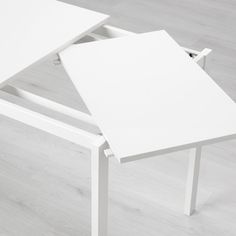 a white table sitting on top of a hard wood floor