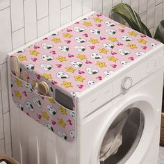 a washer and dryer sitting next to each other in front of a tiled wall