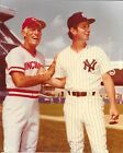 two baseball players standing next to each other on a field