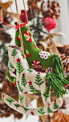 a christmas ornament hanging from a tree in the shape of a rocking horse