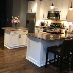 a kitchen with white cabinets and an island