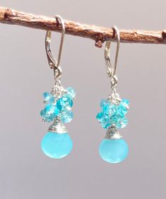 Wow! These little beauties are a fun color! Vibrant, Caribbean blue Peruvian Chalcedony briolettes are accompanied by a cluster of Apatite above. These will brighten any day.  These earrings hang 1" long on secure sterling silver lever backs. Proudly made by hand in Colorado. Nickel Free Blue Aquamarine Earrings, Blue Aquamarine Nickel-free Earrings, Blue Aquamarine Earrings Nickel Free, Blue Dangle Birthstone Earrings, Hypoallergenic Blue Briolette Earrings, Blue Birthstone Dangle Earrings, Caribbean Blue, Fun Color, Made Jewelry