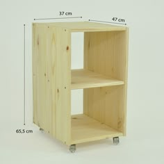 a wooden shelf sitting on wheels with measurements