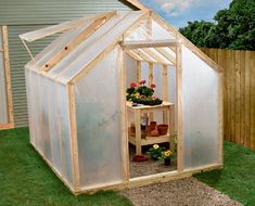 a small greenhouse with plants growing inside