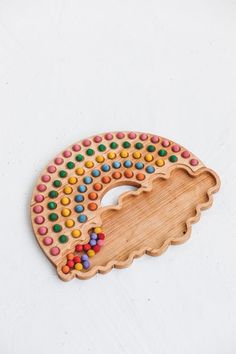 a wooden brooch with colorful beads on it