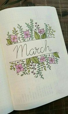 an open notebook with flowers and the word march written in cursive writing