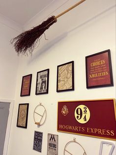 a broom hanging from the side of a wall with harry potter's express signs on it