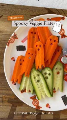 a white plate topped with carrots and cucumbers covered in fake ghost faces