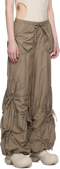 Wide-leg nylon- and cotton-blend taffeta trousers. Ruched drawstring pouches throughout. · High rise · Drawstring at elasticized waistband and cuffs · Two-pocket styling · Logo embroidered at front · Unlined Supplier color: Sand gray Luxury Nylon Bottoms With Multiple Pockets, Luxury Vintage Pre-washed Bottoms, Luxury Tapered Leg Parachute Pants For Streetwear, Entire Studios Ssense Skirt, Saytr Pants, Junya Watanabe Parachute Pants, Paratuche Pants, Solder Pants, Hablon Fabric