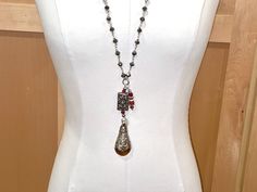 Rich, luxe, one of a kind, this unique necklace is pretty breathtaking. The chain is made of large, faceted, shiny silver PYRITE rondelles, and, without accouterments, measures 32" in length, which means you get a 16" drop. If you add the multiple pendants and accouterments at the bottom, you gain an additional 5 1/4" of wearable drop length. This lovely piece slips over the head with ease. The pendants are TIBETAN CARNELIAN, handmade by the tribespeople of Tibet. The FOCI pendant at the bottom is a fantastic 2 3/8" long and1 1/4" wide Tibetan smooth and gorgeous carnelian stone. It is capped almost 3/4" of the way down with magnificent TIBETAN STERLING SILVER which is ornately carved using a repousse technique. Above this piece is a secondary Tibetan sterling piece, a rectangular massivel Elegant Silver Drop Necklace With Natural Stones, Silver Carnelian Bohemian Necklaces, Silver Carnelian Bohemian Necklace, Bohemian Silver Carnelian Necklaces, Silver Teardrop Necklaces With Unique Variations, Silver Gemstone Long Drop Necklaces, Silver Long Drop Gemstone Necklaces, Artisan Teardrop Pendant Necklace, Silver Drop Spiritual Necklace