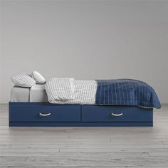 a blue bed with two drawers underneath it