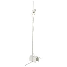 a white floor lamp with two lights on each side and one light on the other