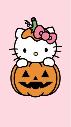 hello kitty sitting on top of a jack - o'- lantern with a pink background