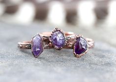 This listing is for one made-to-order raw amethyst crystal ring that is outrageously gorgeous, organic, and rustic. The deeply purple stones are set on an elegant floral copper band.  I created the ring with a technique called electroforming. Copper is deposited over the stone over 12-24 hours using electrical currents. It creates a gorgeously organic and hefty piece with a setting that looks like animal skin or something pried right out of the earth. The copper has been given a darkened patina Bohemian Amethyst Wedding Jewelry, Rustic Hand Forged Ring Jewelry, Rustic Ring Jewelry Gift, Spiritual Stackable Amethyst Jewelry, Rustic Gemstone Jewelry For Gifts, Nature-inspired Amethyst Gemstone Jewelry, Hand Forged Amethyst Ring As Gift, Nature-inspired Amethyst Healing Jewelry, Stackable Amethyst Jewelry